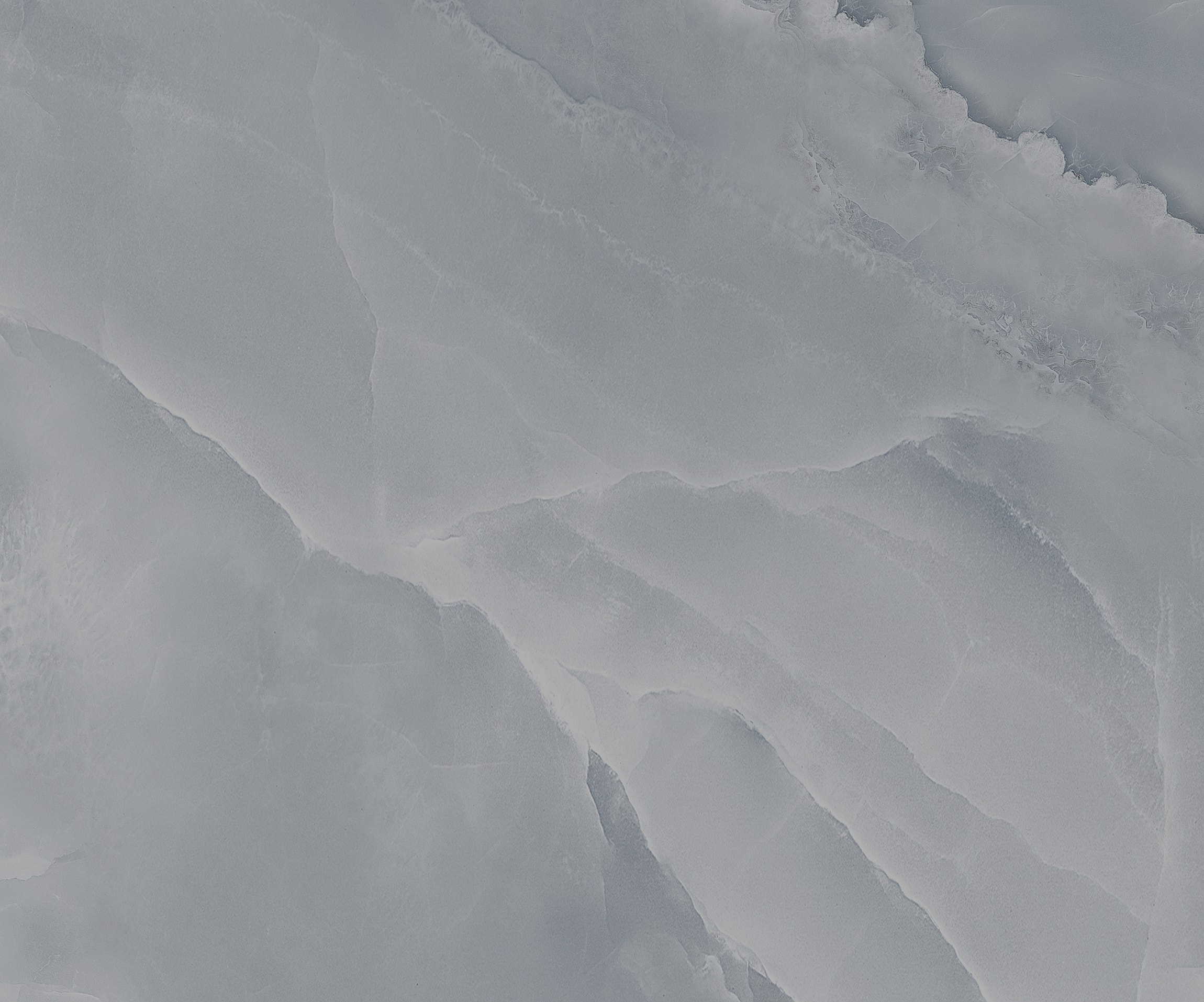 Textured icy surface with soft blue tones.