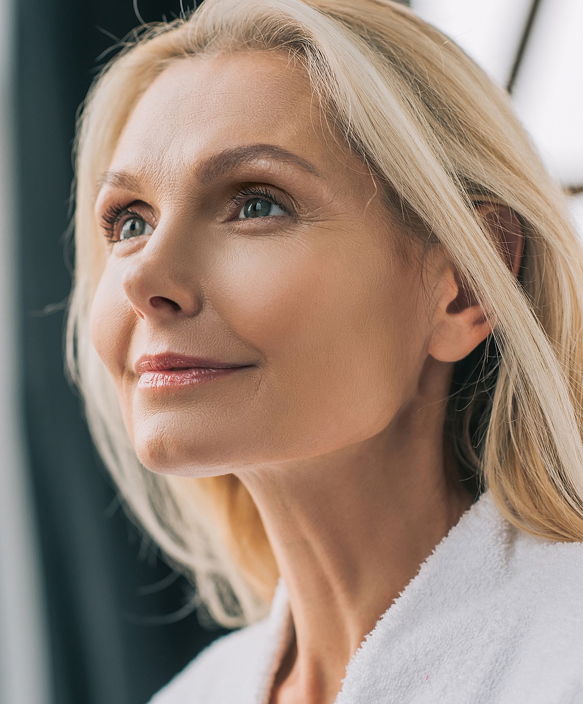 Smiling woman with long blonde hair, close-up.