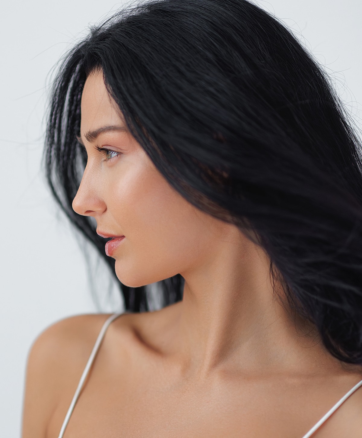 Profile view of woman with flowing black hair.