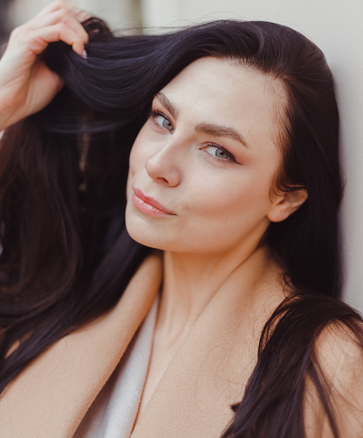 Woman showcasing elegant jewelry and fashion.