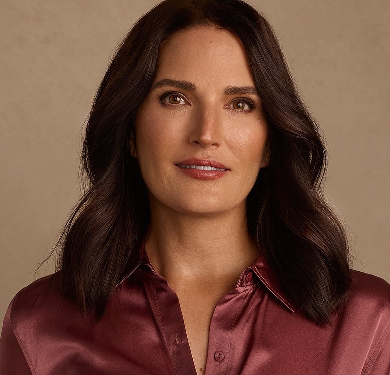 Confident woman in elegant attire and jewelry.