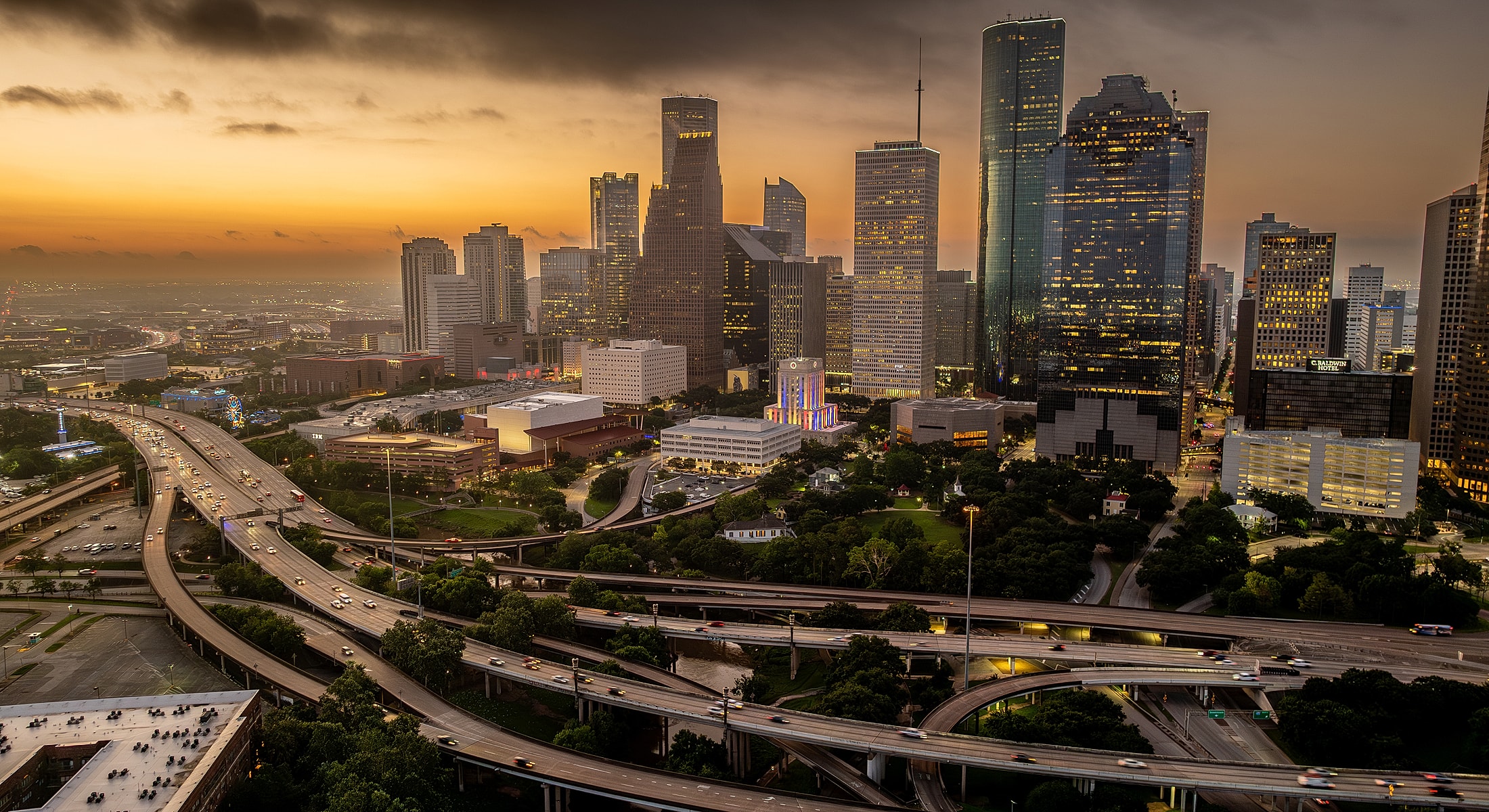 Houston skyline at sunset with busy highways.