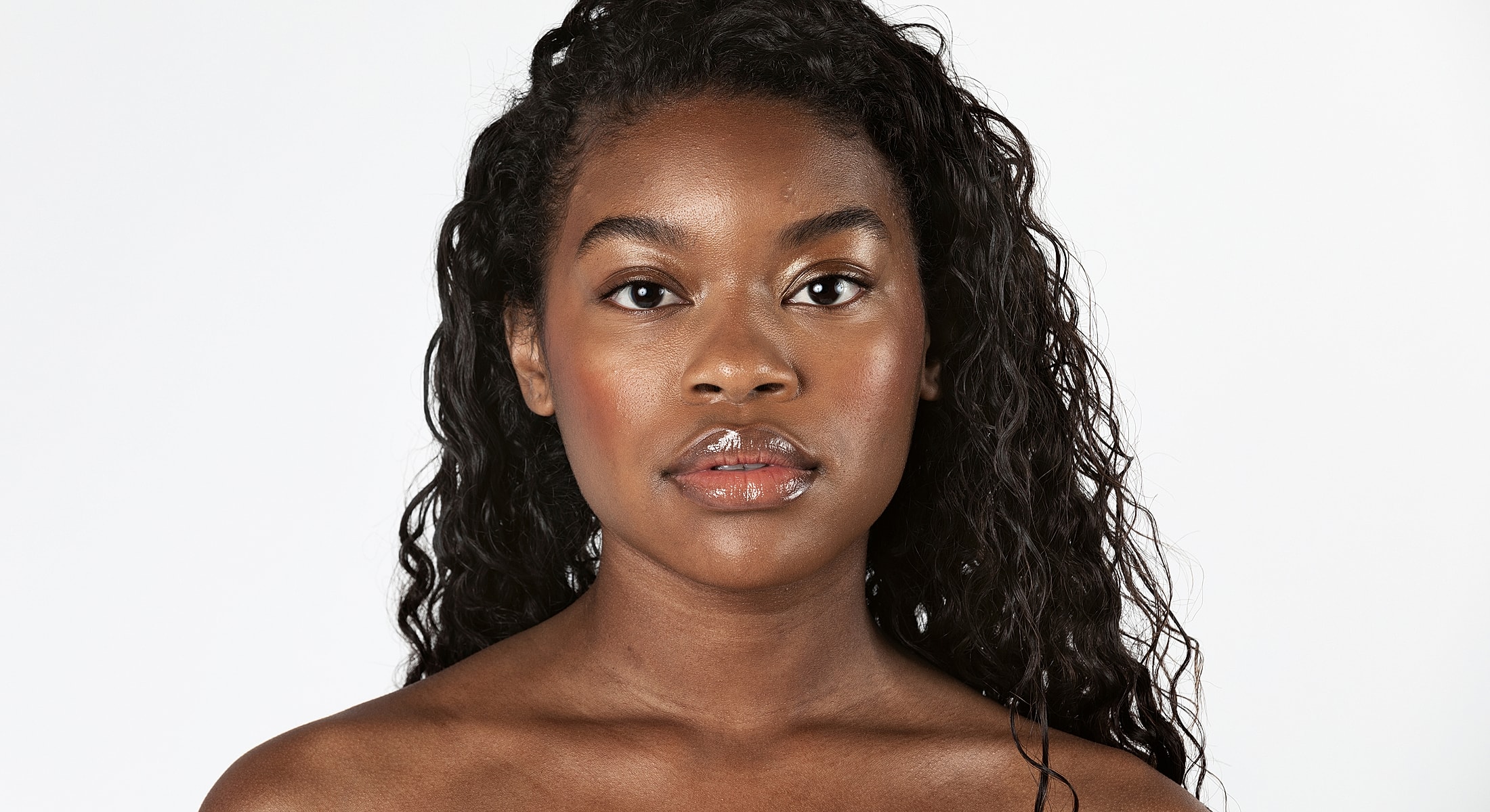 Woman with beautiful skin and curly hair.
